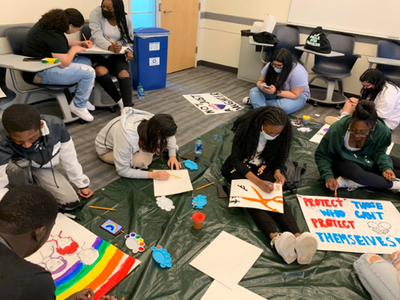 Students creating demonstration signs & art in a hands-on workshop