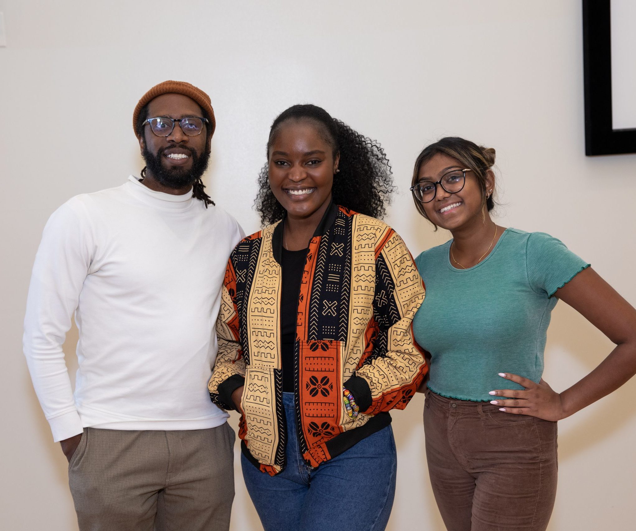 Three students from the Democracy and Dialogues Student Fellowship Program stand next to each other.